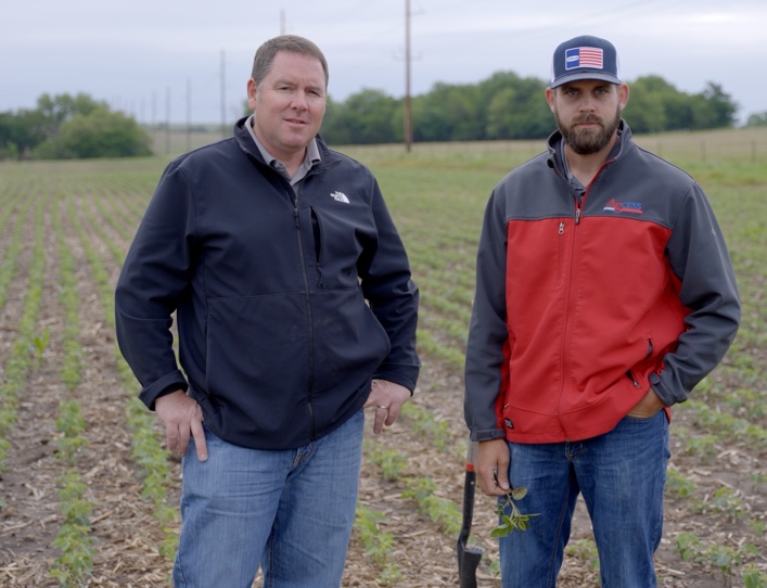 Ben Sauder and Preston Thomas standing in a soybean field